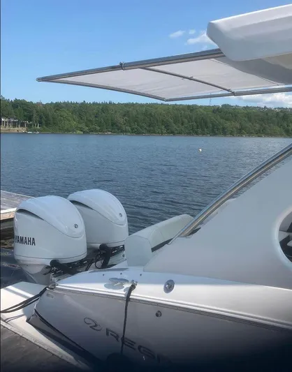  Yacht Photos Pics 2024 Regal 29 OBX boat with Yamaha engines docked by a serene lake.