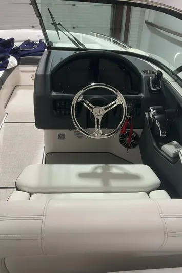  Yacht Photos Pics 2024 Regal 29 OBX boat interior with steering wheel and dashboard.