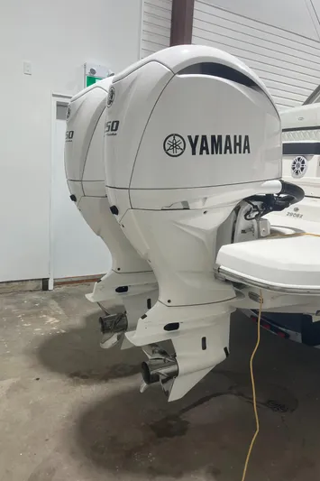  Yacht Photos Pics 2024 Regal 29 OBX with twin Yamaha outboard engines in a garage.