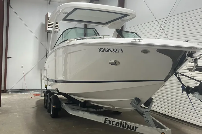  Yacht Photos Pics 2024 Regal 29 OBX boat on Excalibur trailer in storage facility.