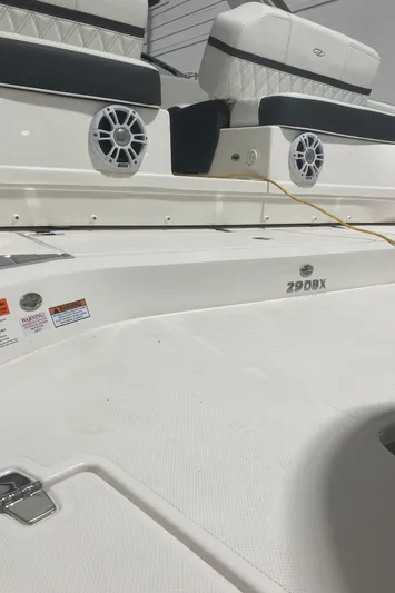  Yacht Photos Pics 2024 Regal 29 OBX boat, white deck, black seating, visible speakers.