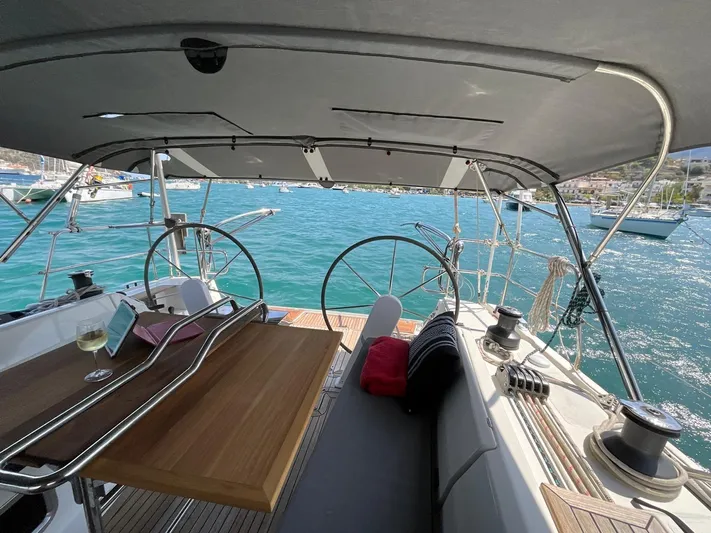 Starla Yacht Photos Pics Spacious cockpit of 2012 Hanse 445 yacht with dual steering wheels and scenic marina view.