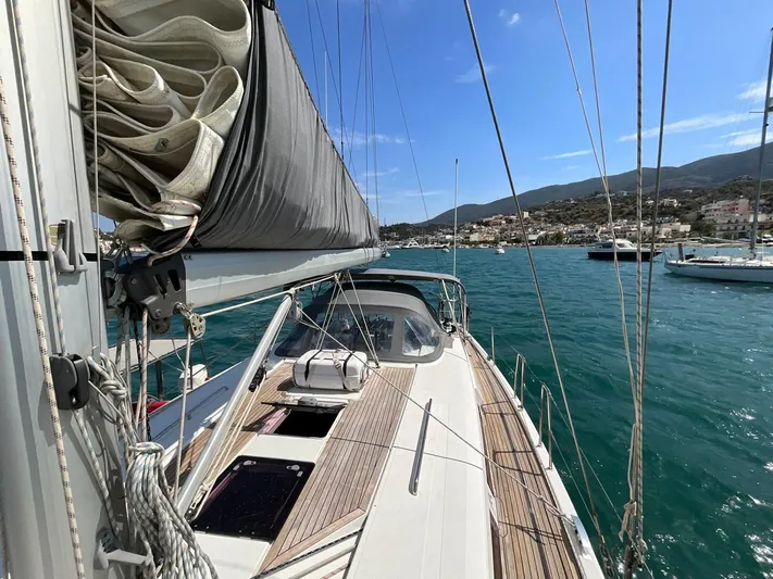 Starla Yacht Photos Pics Sailing yacht Hanse 445, 2012 model, docked in a scenic harbor with clear blue waters.