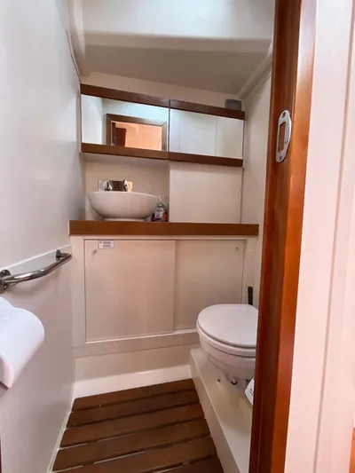 Starla Yacht Photos Pics 2012 Hanse 445 yacht heads with modern sink, toilet, and wooden accents.