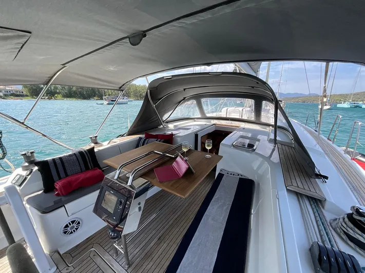 Starla Yacht Photos Pics Spacious cockpit of 2012 Hanse 445 yacht with seating, table, and scenic ocean view.