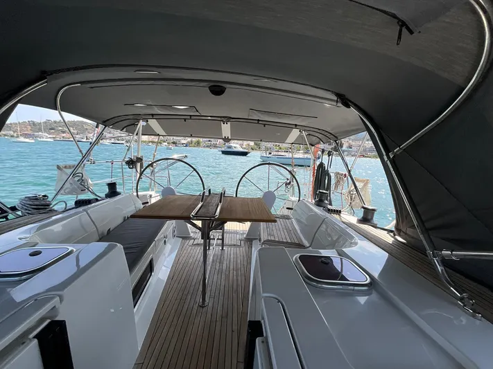 Starla Yacht Photos Pics 2012 Hanse 445 yacht interior with wooden deck, dual steering wheels, and ocean view.