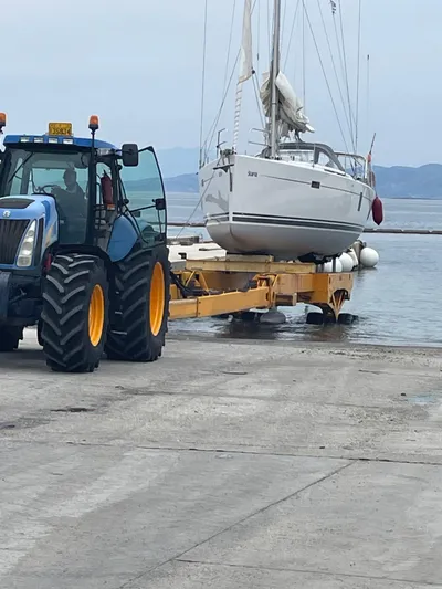 Starla Yacht Photos Pics Tractor transporting 2012 Hanse 445 sailboat from water to shore.
