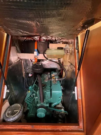 Starla Yacht Photos Pics Engine compartment of a 2012 Hanse 445 sailboat, featuring a green marine engine.