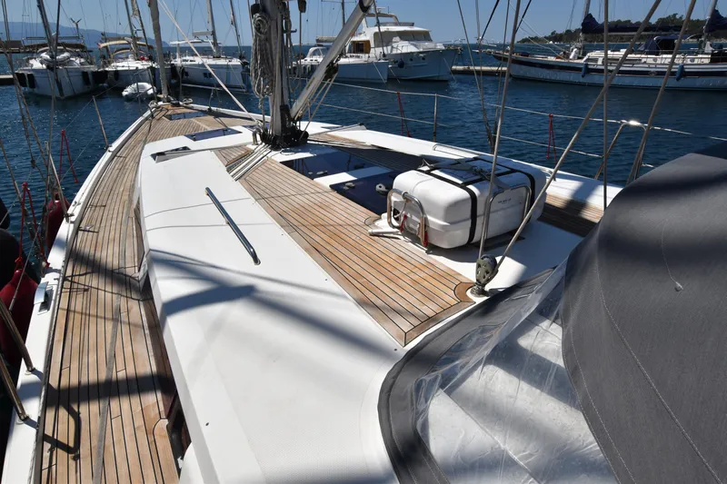 Starla Yacht Photos Pics 2012 Hanse 445 yacht deck with wooden finish, docked at a marina.