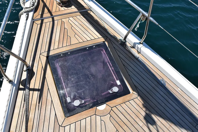Starla Yacht Photos Pics Teak deck of 2012 Hanse 445 sailboat with hatch, ocean view.