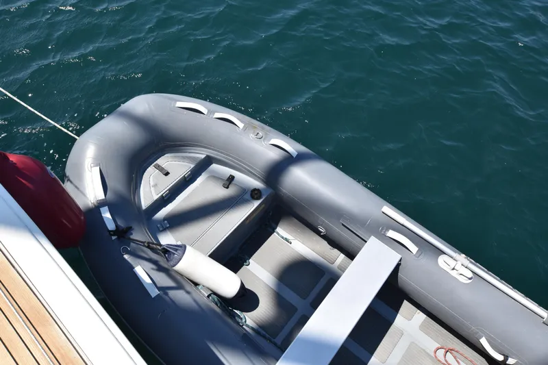 Starla Yacht Photos Pics Inflatable dinghy alongside 2012 Hanse 445 yacht on clear blue water.