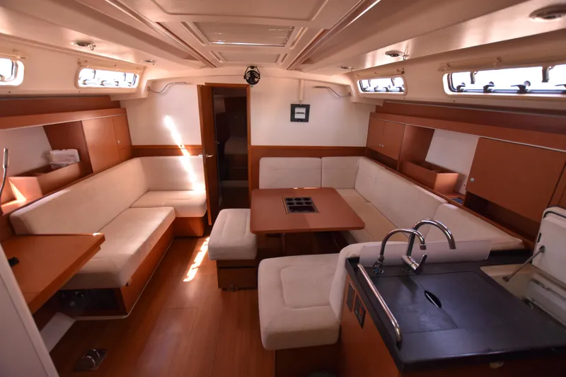 Starla Yacht Photos Pics Luxurious interior of 2012 Hanse 445 yacht with spacious seating and modern kitchen area.