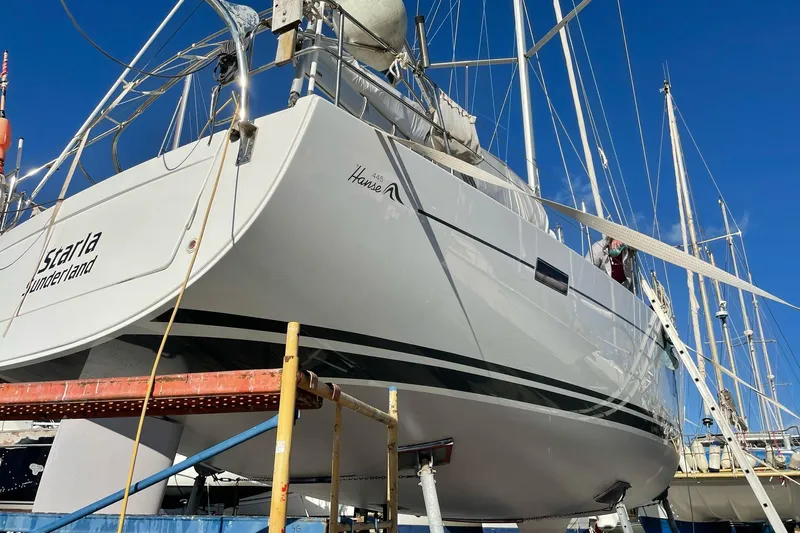 Starla Yacht Photos Pics 2012 Hanse 445 sailboat on dry dock, clear blue sky background.