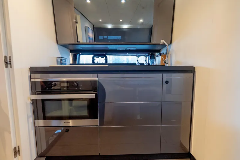 Azul Yacht Photos Pics Modern kitchen interior of 2021 Azimut Verve 47 yacht with sleek cabinetry and appliances.