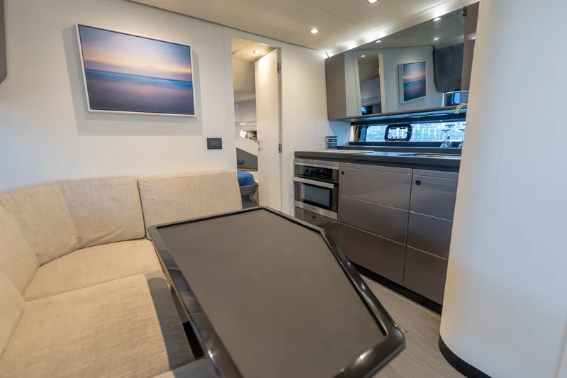 Azul Yacht Photos Pics Interior of 2021 Azimut Verve 47 yacht with modern kitchen and seating area.