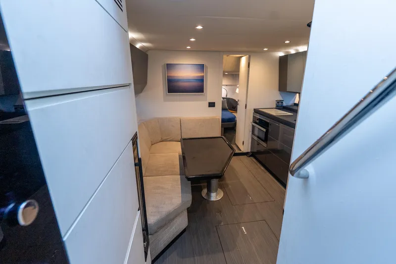 Azul Yacht Photos Pics Interior of 2021 Azimut Verve 47 yacht with modern kitchen and cozy seating area.