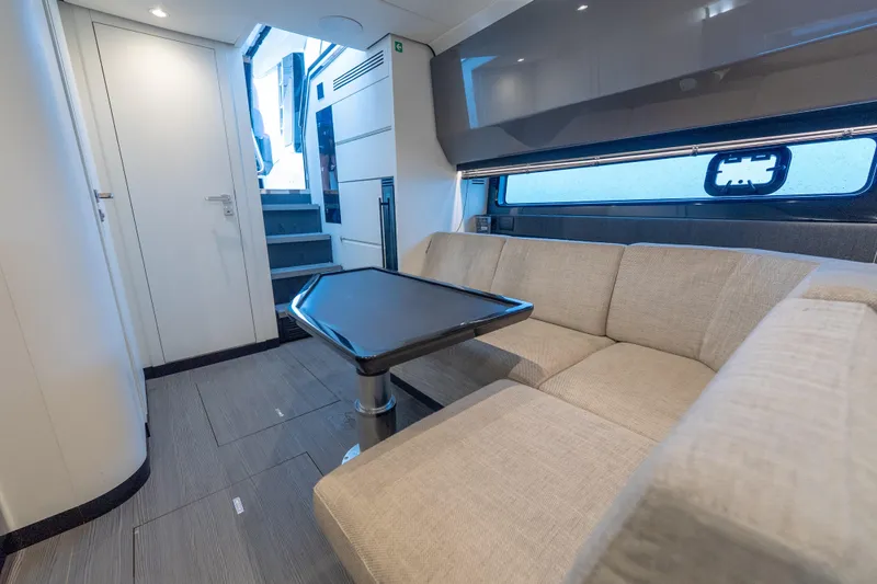 Azul Yacht Photos Pics Luxurious interior of 2021 Azimut Verve 47 yacht with modern seating and table.