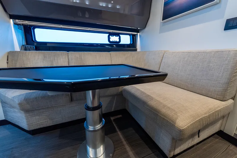 Azul Yacht Photos Pics Interior of 2021 Azimut Verve 47 yacht with beige seating and sleek black table.