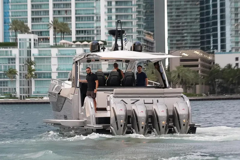 Azul Yacht Photos Pics 2021 Azimut Verve 47 yacht cruising near modern waterfront buildings.