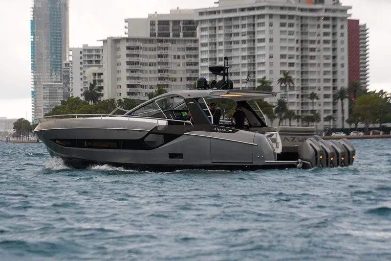 Azul Yacht Photos Pics 2021 Azimut Verve 47 yacht cruising near urban waterfront buildings.