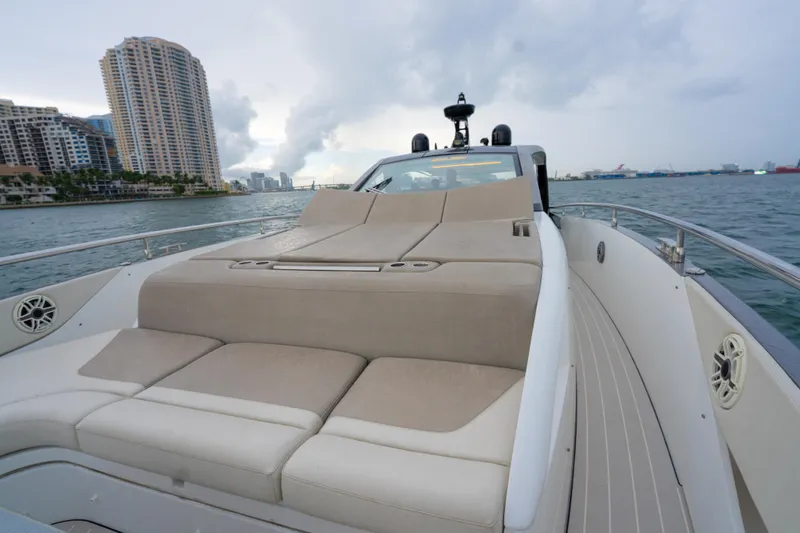 Azul Yacht Photos Pics 2021 Azimut Verve 47 yacht with luxurious deck seating, cruising near city skyline.