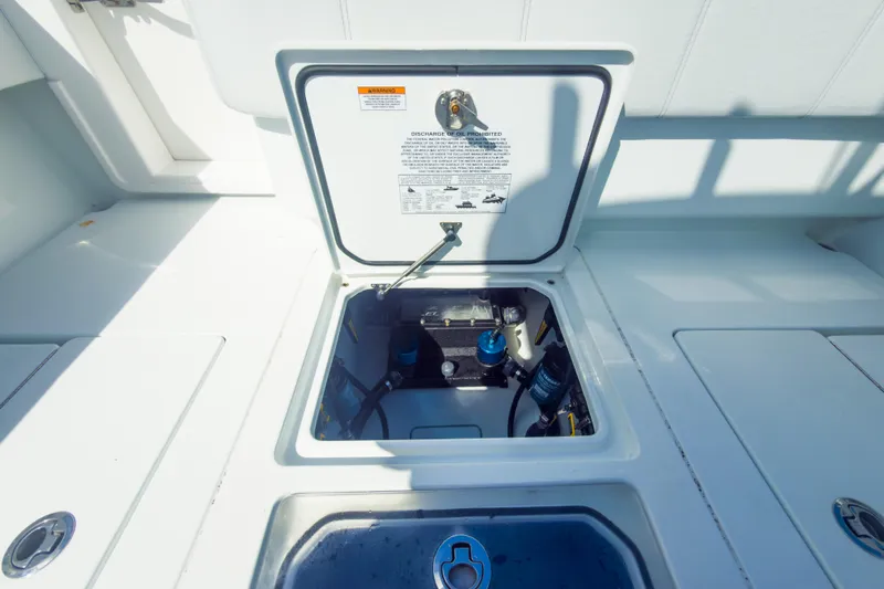 No Name Yacht Photos Pics 2023 Contender 32 ST boat hatch open, revealing internal components and storage area.