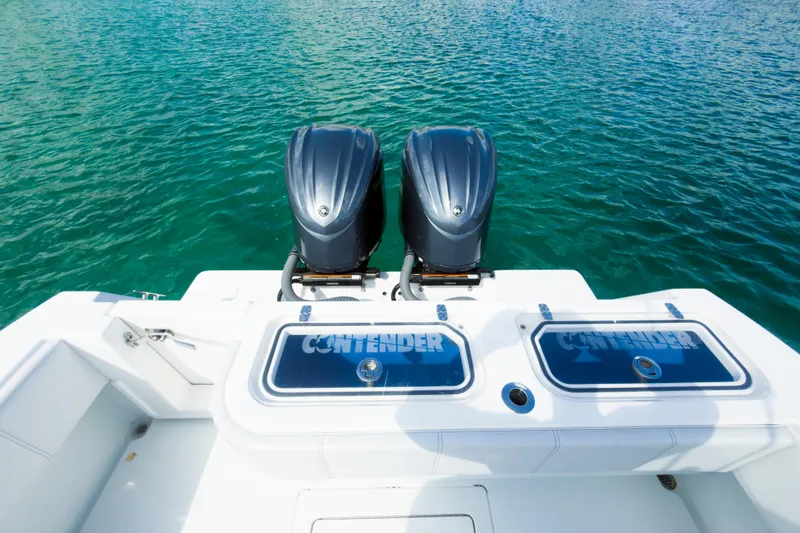 No Name Yacht Photos Pics 2023 Contender 32 ST boat with dual engines on clear blue water.