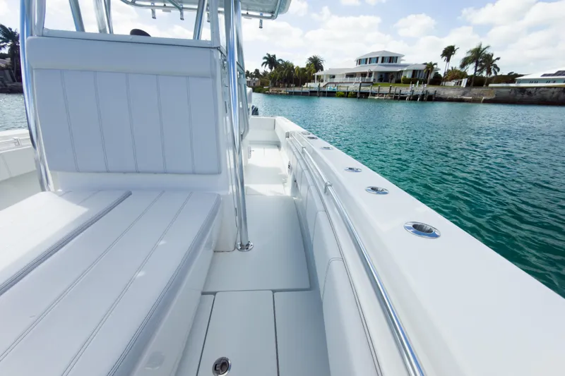 No Name Yacht Photos Pics 2023 Contender 32 ST boat interior with waterfront view, showcasing sleek design and seating.