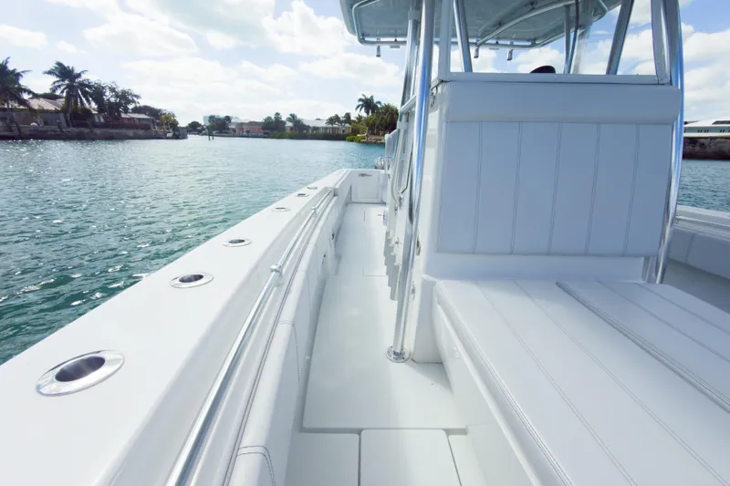 No Name Yacht Photos Pics 2023 Contender 32 ST boat on calm water, showcasing sleek design and spacious seating.