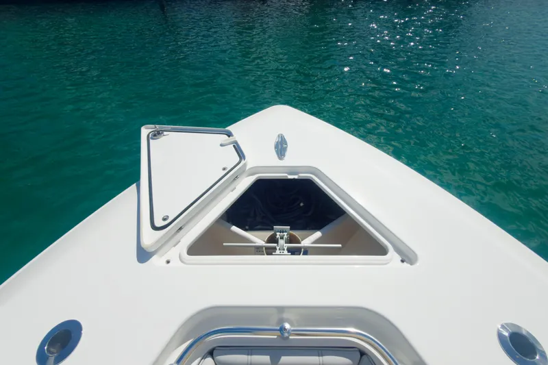 No Name Yacht Photos Pics 2023 Contender 32 ST boat bow with open hatch on clear water.