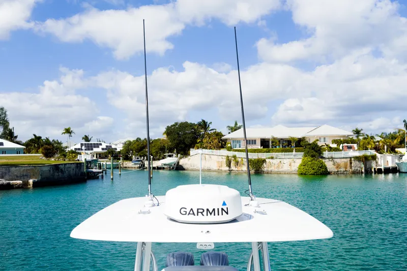 No Name Yacht Photos Pics 2023 Contender 32 ST boat with Garmin equipment in a scenic waterfront setting.