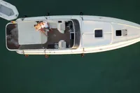Aerial view of a 2007 Performance 1107 boat with people relaxing on deck.