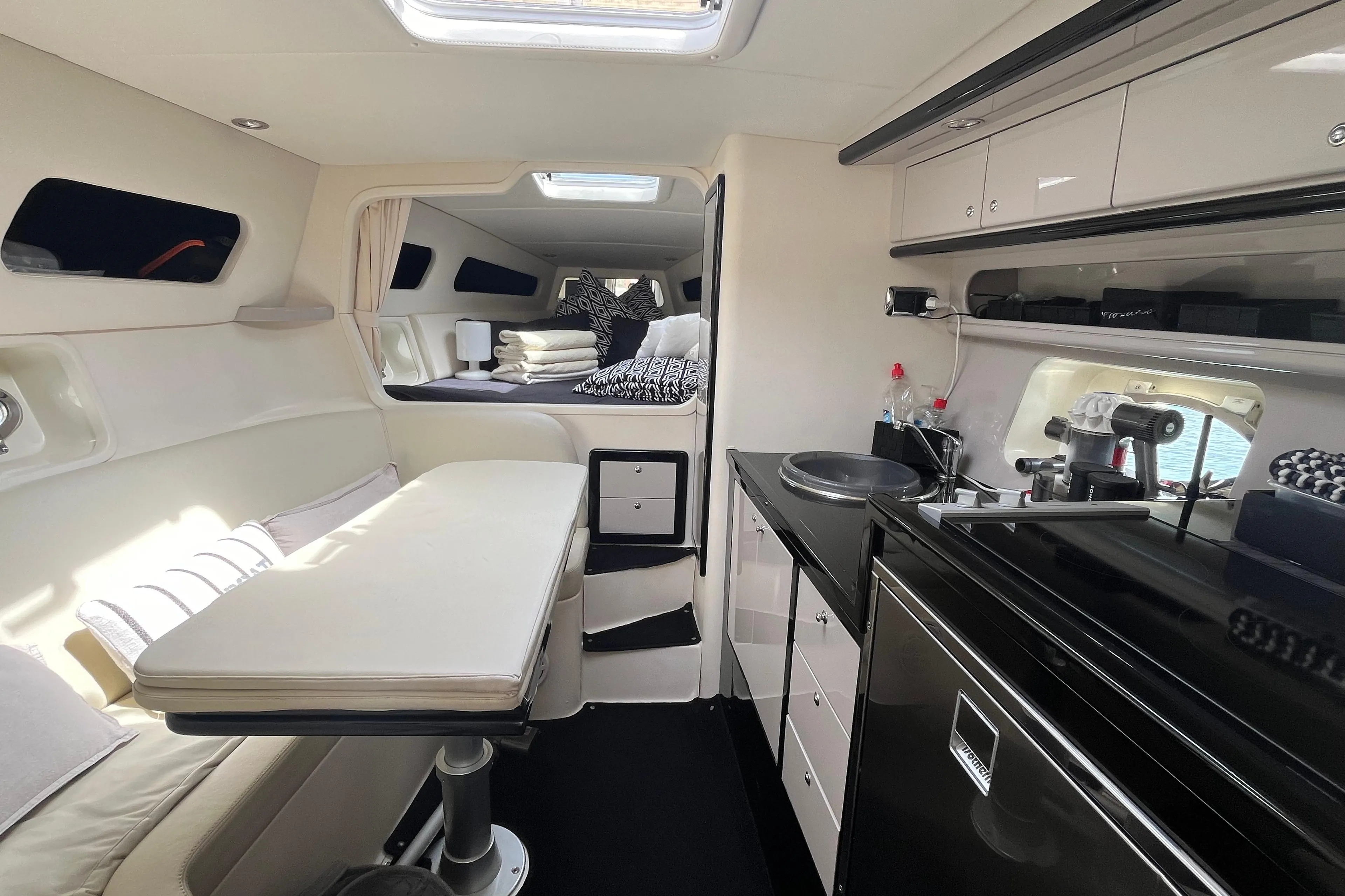 Luxurious 2007 Performance 1107 yacht interior with modern kitchen and cozy seating area.