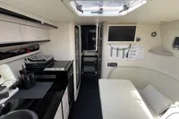 Interior of a 2007 Performance 1107 boat, featuring a compact kitchen and seating area.