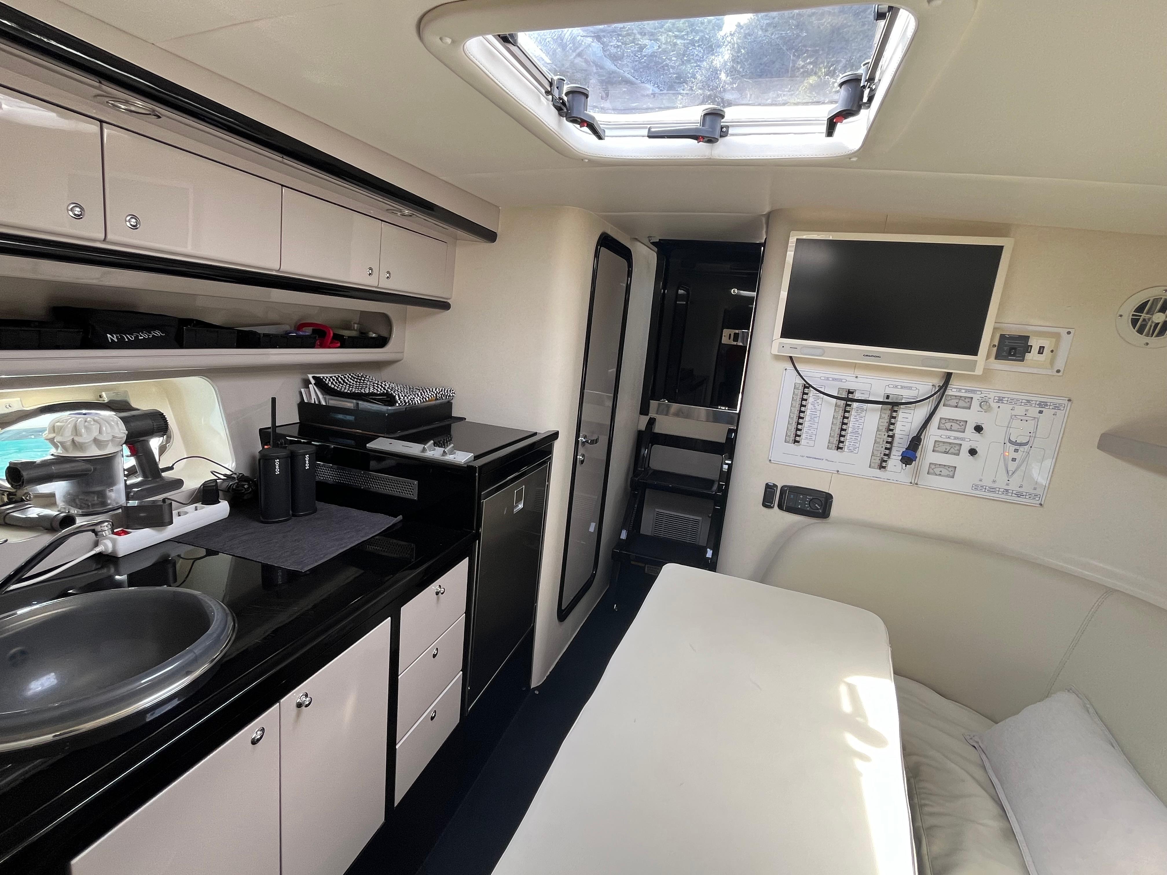 Interior of 2007 Performance 1107 boat with kitchenette, seating, and skylight.
