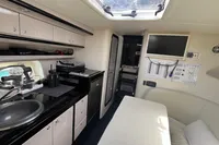 Interior of 2007 Performance 1107 boat with kitchenette, seating, and skylight.