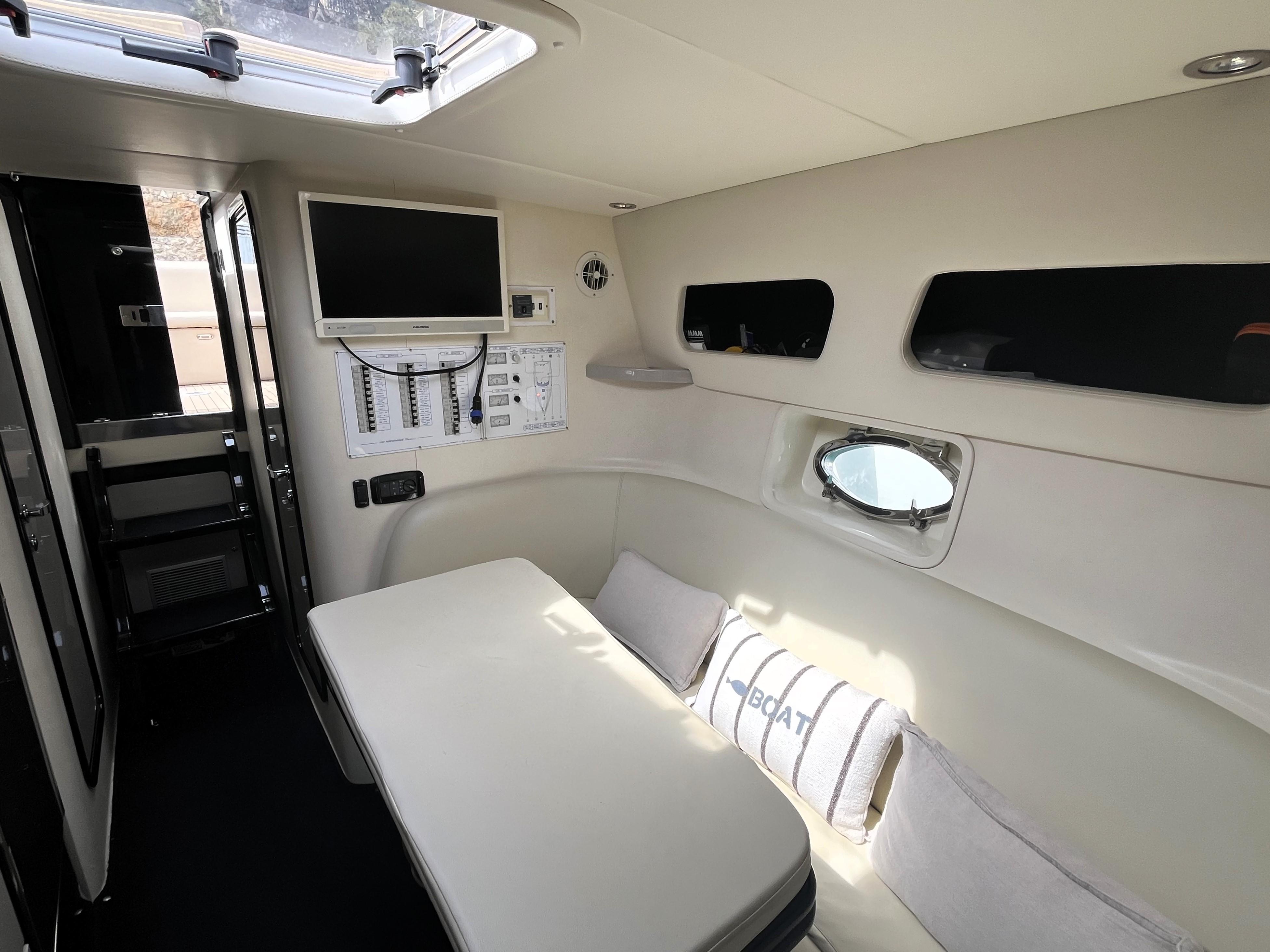 Interior of 2007 Performance 1107 boat with seating, windows, and control panel.