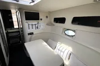 Interior of 2007 Performance 1107 boat with seating, windows, and control panel.