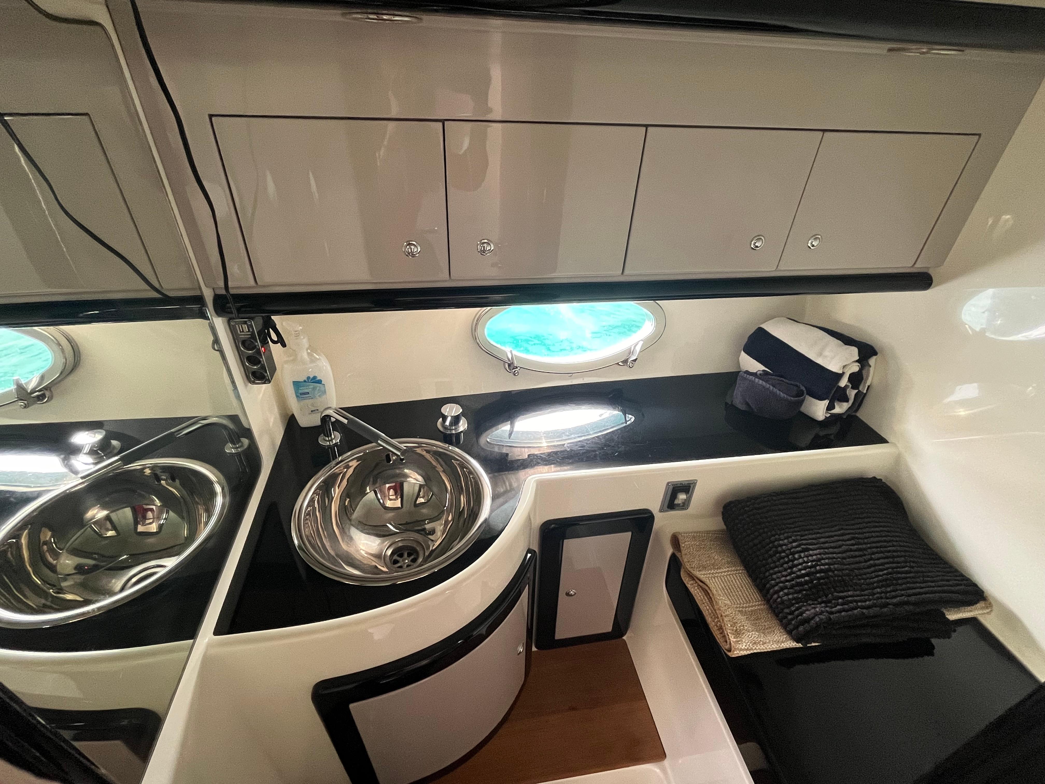 Luxurious 2007 Performance 1107 yacht interior with sink, storage, and porthole.
