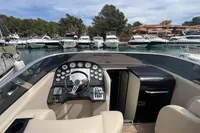 Luxury Performance 1107 boat interior, 2007 model, docked at marina with yachts in background.