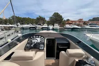 Luxury yacht Performance 1107, 2007 model, docked in marina with scenic background.