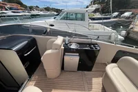 Luxury boat deck with seating, mini kitchen, and scenic marina view, Performance 1107, 2007 model.