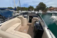 Luxurious 2007 Performance 1107 yacht interior with beige seating, docked in a marina.
