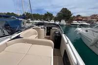 Luxury Performance 1107 boat, 2007 model, docked in a marina with plush seating.