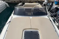 2007 Performance 1107 boat docked, featuring beige upholstery and sleek design.