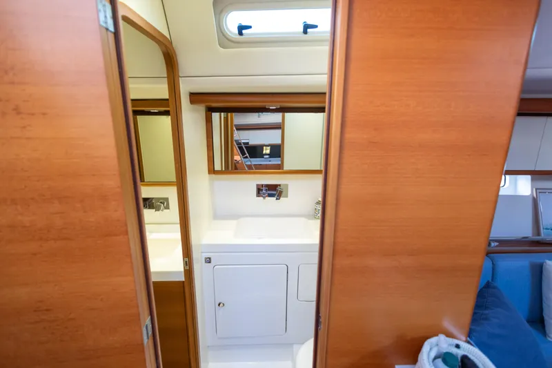  Yacht Photos Pics Interior of 2014 Italia Yachts 15.98, featuring a wooden bathroom with mirror and sink.