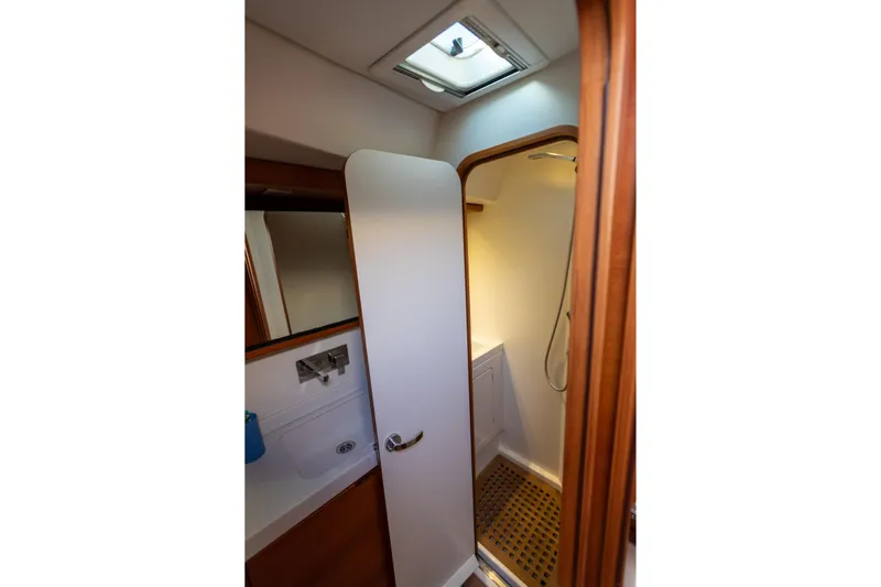 Yacht Photos Pics Luxurious bathroom interior of 2014 Italia Yachts 15.98 with shower and wooden accents.