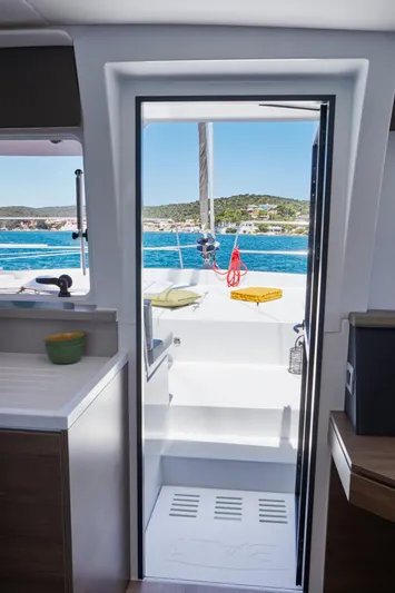  Yacht Photos Pics Interior view of 2025 Bali 4.4 yacht, showcasing doorway to sunlit deck and ocean.