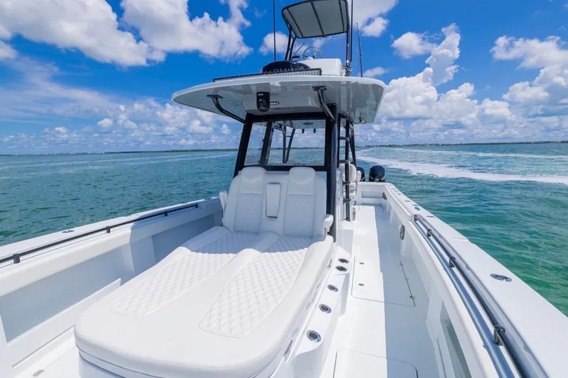  Yacht Photos Pics 2026 Invincible 36 Catamaran cruising on clear blue waters under a bright sky.