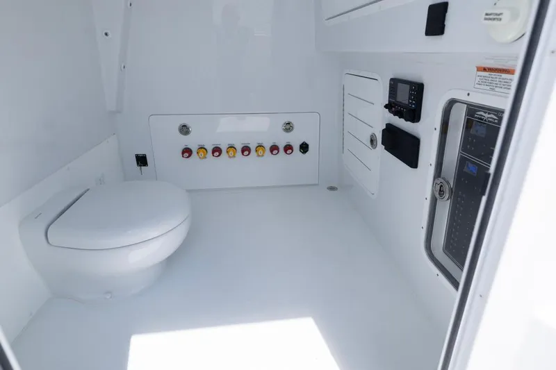  Yacht Photos Pics Interior of 2026 Invincible 36 Catamaran featuring a modern marine toilet and control panel.